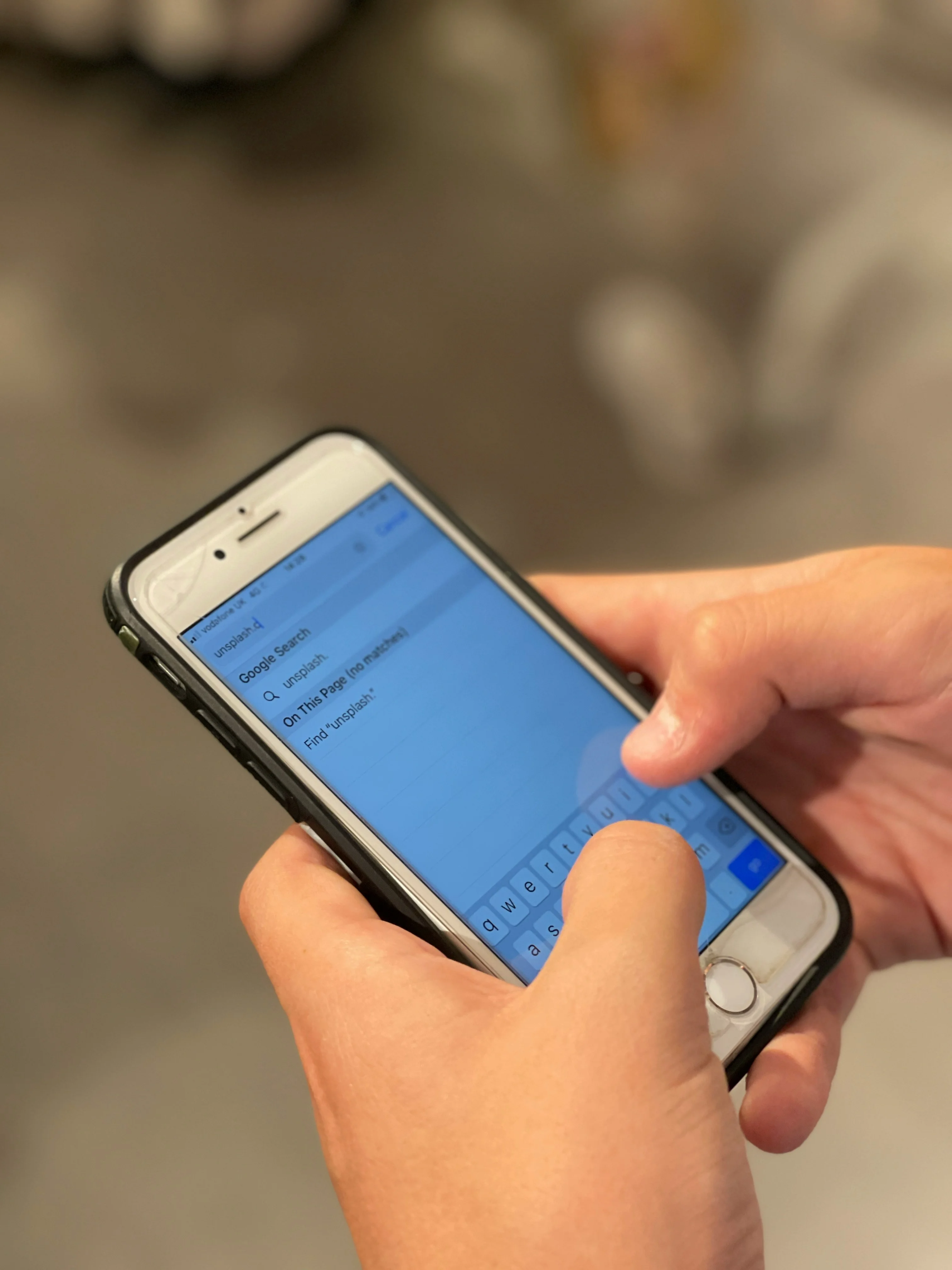 Person making a mobile Google search on an iPhone